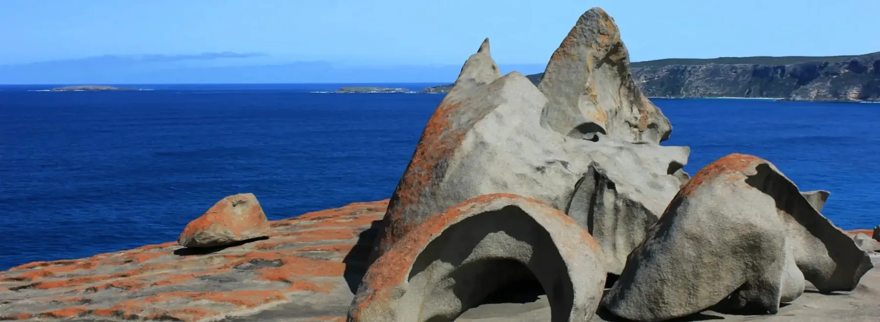 Weathered granite above the surf on the island south coast