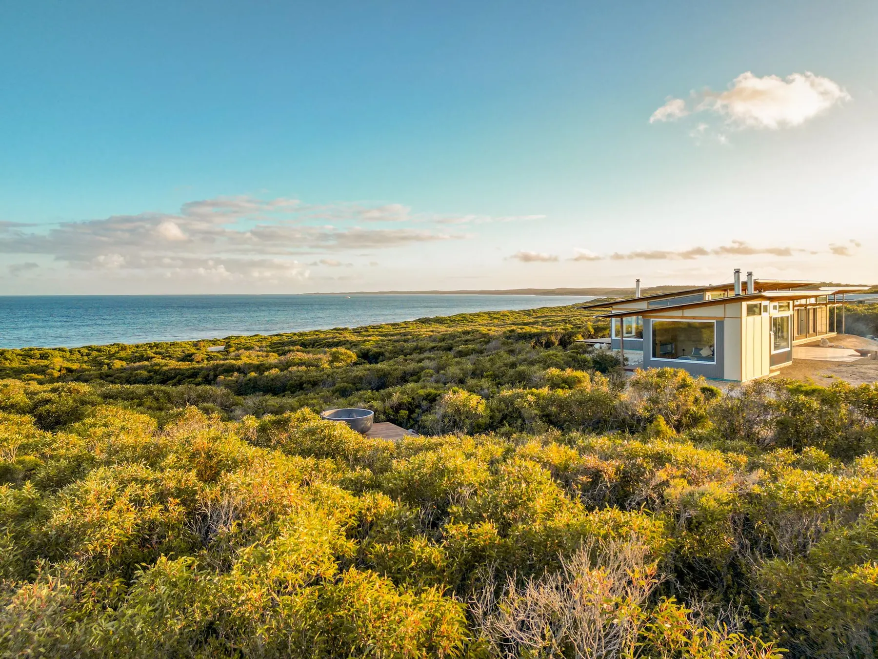 Aerial view of the retreat above D'Estrees Bay at golden hour