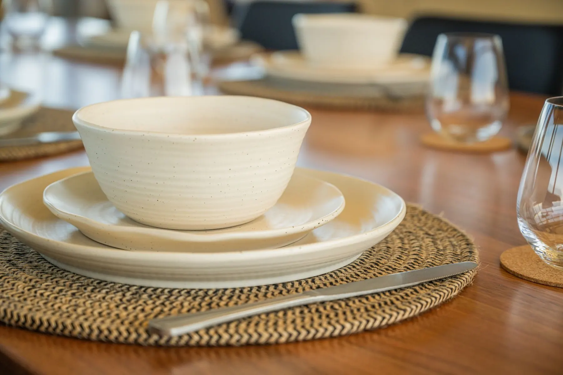The table set with linen, glassware and island produce