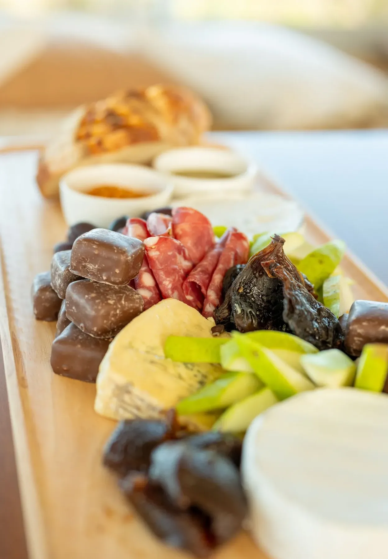 Grazing board with cheeses, salami, figs, honeycomb, pear and dips